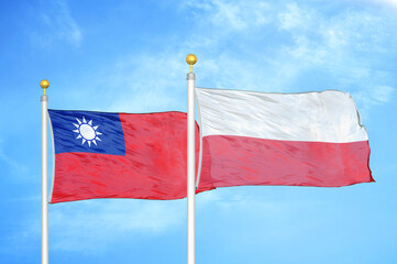 Taiwan and Poland two flags on flagpoles and blue sky