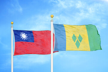 Taiwan and Saint Vincent and the Grenadines two flags on flagpoles and blue sky