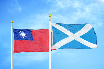 Taiwan and Scotland two flags on flagpoles and blue sky