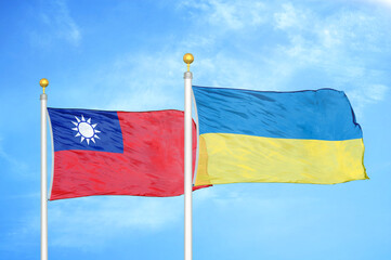 Taiwan and Ukraine two flags on flagpoles and blue sky