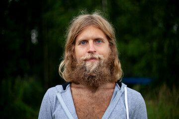 A guy with a big beard. The man travels in nature. 
