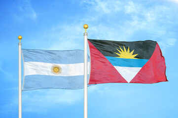 Argentina and Antigua and Barbuda two flags on flagpoles and blue sky