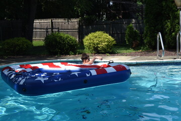 Obraz premium Teens have fun in swimming pool in the summer 2020. Home water kids party 