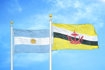 Argentina and Brunei two flags on flagpoles and blue sky