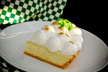 Meringue lemon tart slice in a plate 