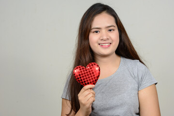 Portrait of happy young beautiful Asian woman