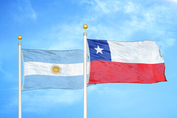 Argentina and Chile two flags on flagpoles and blue sky