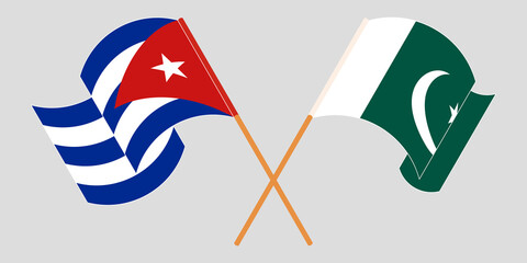 Crossed and waving flags of Pakistan and Cuba