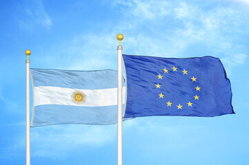 Argentina and European Union two flags on flagpoles and blue sky