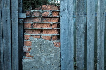 old ruined brickwork and a surface of vintage wooden boards