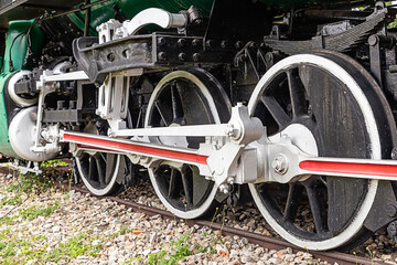 the old locomotive the big iron wheels of the steam train stands on the tracks