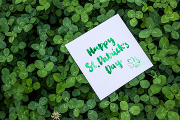 Green clover holiday border, st.Patrick's day decoration background with card Happy St. Patrick's...