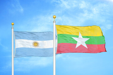 Argentina and Myanmar two flags on flagpoles and blue sky