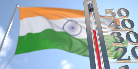 Thermometer shows high air temperature against blurred flag of India. Hot weather forecast related 3D rendering
