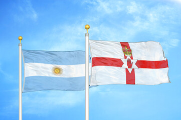 Argentina and Northern Ireland two flags on flagpoles and blue sky