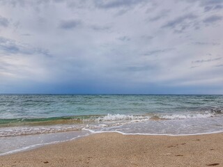 Fototapeta na wymiar Crimea. Belyaus Beach. The sea before the rain. Small wave.