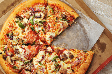 Meat pepper pizza lies on cardboard packaging