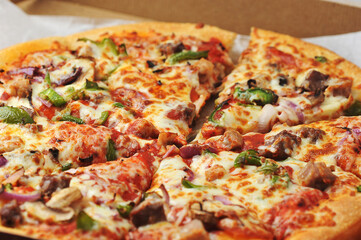 Meat pepper pizza lies on cardboard packaging