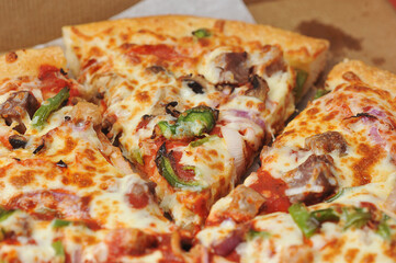 Meat pepper pizza lies on cardboard packaging