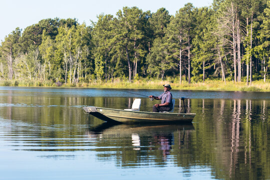 Mature man enjoying retirement and fishing on family lake