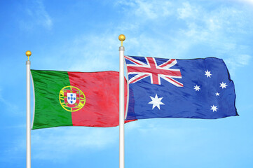 Portugal and Australia two flags on flagpoles and blue sky