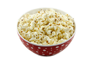 Salted popcorn in a red plate with polka dots. Isolated on white background no people. Close-up, side view.