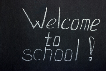 Fototapeta premium Lettering on the chalk board welcome to school. Greeting students