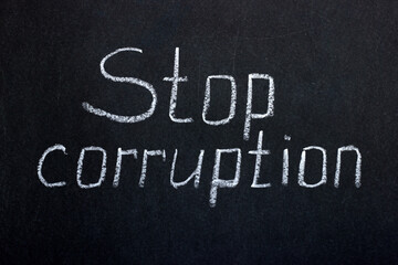 Obraz premium Chalkboard lettering stop corruption. Reflection of social problems
