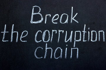 Obraz premium Chalkboard writing break the chain of corruption. A call to tackle social problems