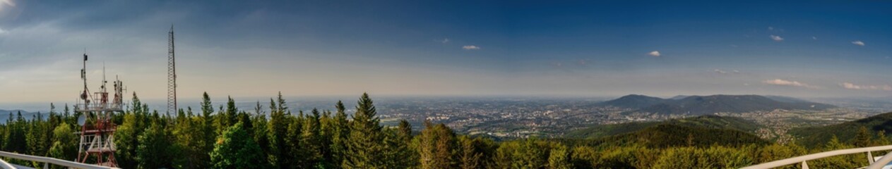 Bielsko Biala, South Poland: Wide angle from up above panoramic detailed high definition view of scenic mountains, green forest and city against blue sky