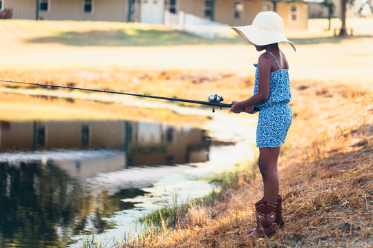 Young Girl Fishing On Family Farm