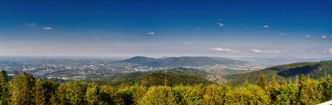 Bielsko Biala, South Poland: Wide angle from up above panoramic detailed high definition view of scenic mountains, green forest and city against blue sky