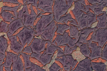 Texture of old painted wall, covered with cracks and roughness close-up. Craquelure on old surface. Violet old cracked paint background. Grunge background texture colored wall in old cracked paint