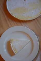 slice of riccota cake on white plate seen from above