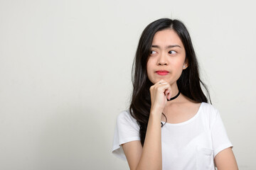 Fototapeta premium Portrait of young beautiful Asian woman against white background