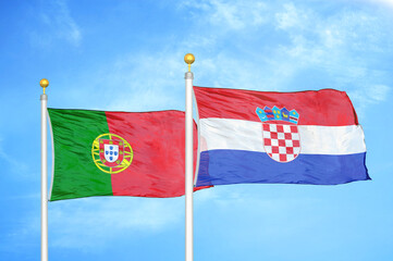 Portugal and Croatia two flags on flagpoles and blue sky