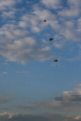 Obraz na płótnie Canvas three skydivers in the cloudy sky