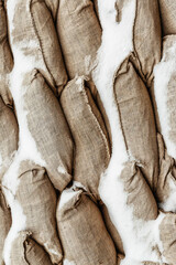 Obraz premium Many gray sandbag. Pattern closeup vertical background protection military design base