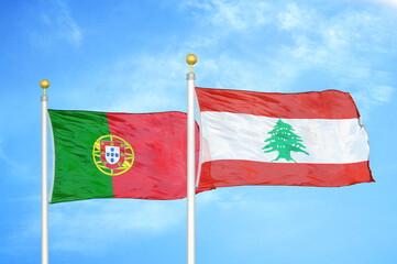 Portugal and Lebanon two flags on flagpoles and blue sky