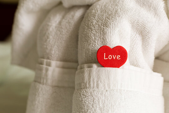 arrangement of towels and a heart symbol of love room decoration wedding newlyweds