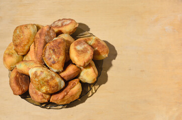 Homemade doughnuts in a glass plate on a wooden background. Baking at home.