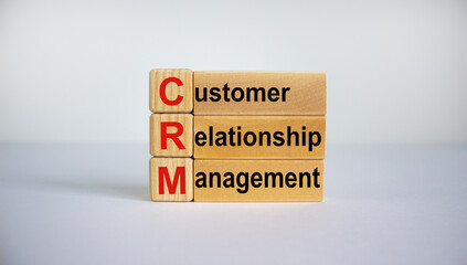 Naklejka premium Concept words 'CRM, customer relationship management' on cubes and blocks on a beautiful white background. Business concept. Copy space.