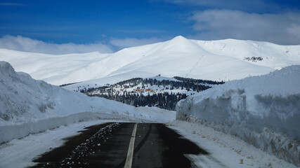 Transalpina Road full of snow. High altitude mountain road