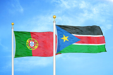Portugal and South Sudan two flags on flagpoles and blue sky
