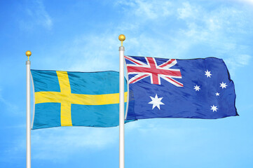 Fototapeta premium Sweden and Australia two flags on flagpoles and blue sky