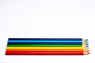 Collection of colored pencils lined up rainbow order
