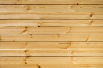 The wall is covered with planks made of natural pine.