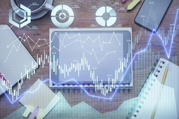 Double exposure of forex chart hologram over desktop with phone. Top view. Mobile trade platform concept.