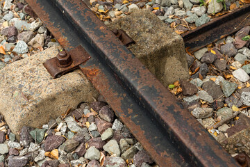 iron rusty rail on a concrete gray tie with a close-up closeup