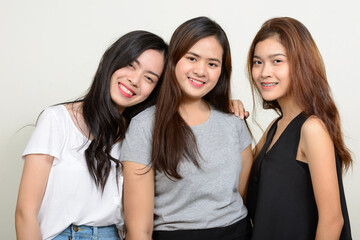 Portrait of three young Asian women as friends together